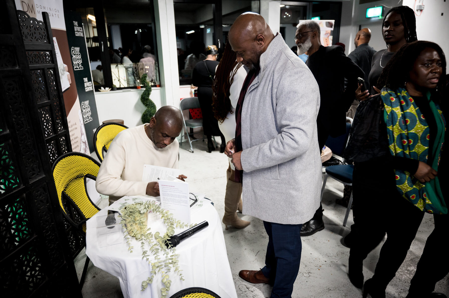 A reader having their copy of Dominion Mandate signed at the London launch